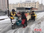 南京城管在雪中帮助市民。　马惠琴 摄 - 江苏新闻网