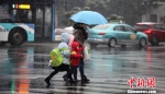 图为家长冒雪送孩子上学。　孟德龙 摄 - 江苏新闻网