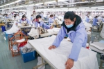 工作人员在江苏红豆集团一般性防护服生产线上作业(2月8日摄)。新华社记者 李博 摄 - 江苏新闻网