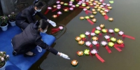 25日上午，在南京市仙灵陵园，“疫情无情仙灵有爱”2020年清明仙灵陵园集体代祭扫仪式举行。莲花池中，工作人员放入盏盏莲花灯，为故人祈福。　泱波　摄 - 江苏新闻网