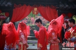 新郎为新娘掀起红盖头。　孟德龙 摄 - 江苏新闻网