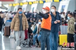 杭州东站铁路志愿者为旅客指引检票口方向。　曹志刚 摄 - 江苏新闻网
