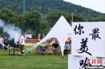 年轻人在露营、烧烤。石瑛 摄 - 江苏新闻网